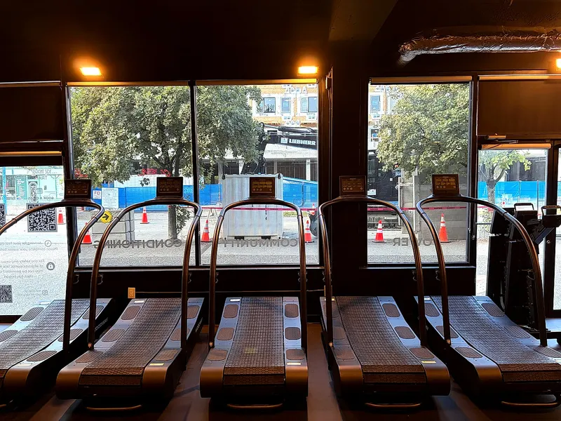 Treadmills used for HIIT classes in front of the studio windows in Lower Lonsdale
