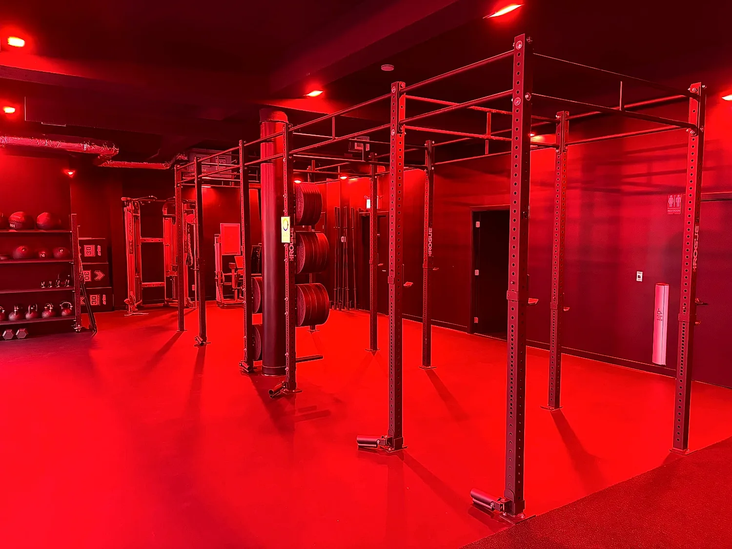 HIIT training floor and rig under red lighting at the Coresa studio in North Vancouver