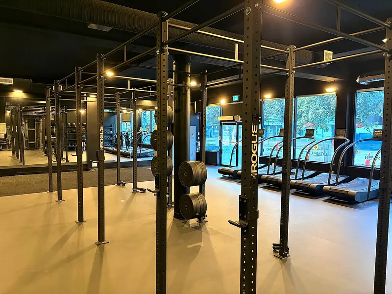Strength training rig and squat racks beside the street windows at the North Vancouver studio