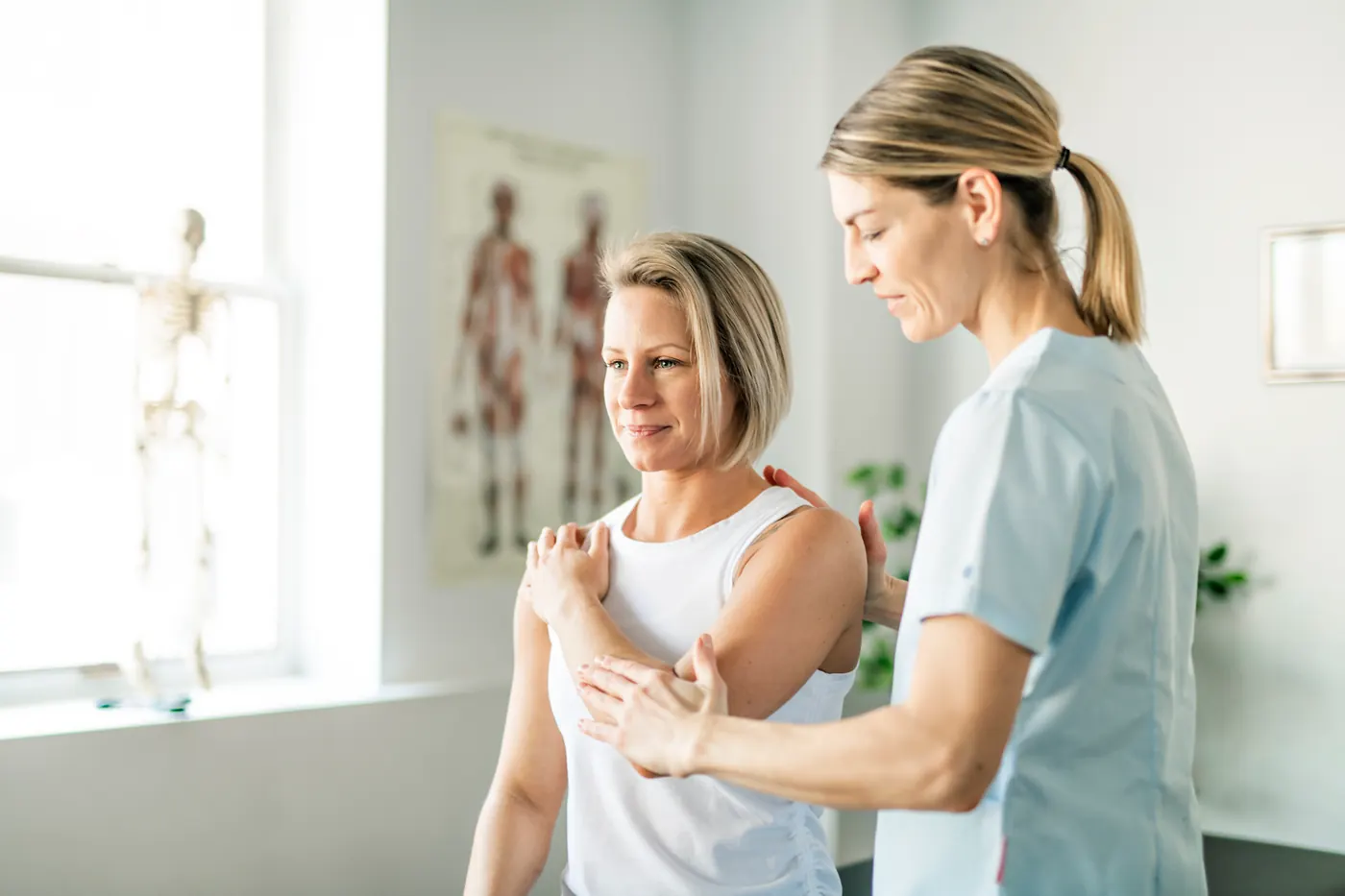 A physiotherapist working with a client during a rehabilitation session