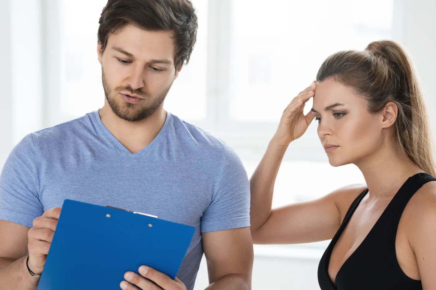 A fitness coach writing out a training plan for a client